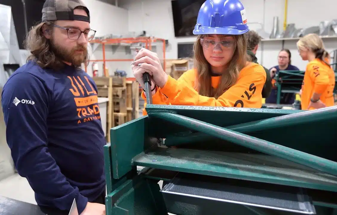 St. Clair College hosted the second annual Jill of All Trades event on Wednesday, May 21, 2025 at the main campus. The event is a hands-on day of activities introducing young women from Grades 9 to 12 to a variety of occupations in the skilled trades. Zachary Elmslie, a graduate of the HVAC technician program watches Ella Hewitt, a North Star High School student perform sheet metal work during the program. Photo by Dan Janisse /Windsor Star