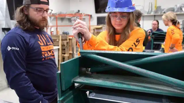 St. Clair College hosted the second annual Jill of All Trades event on Wednesday, May 21, 2025 at the main campus. The event is a hands-on day of activities introducing young women from Grades 9 to 12 to a variety of occupations in the skilled trades. Zachary Elmslie, a graduate of the HVAC technician program watches Ella Hewitt, a North Star High School student perform sheet metal work during the program. Photo by Dan Janisse /Windsor Star